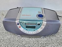 Front angle view showing the top loading CD player door labeled 'Sound Vitalizer' and control buttons around it, with Panasonic branding visible below the cassette slot.