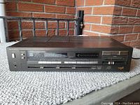 Front view of the Technics SA 311 stereo receiver showing the buttons, tuning dial, and frequency display.