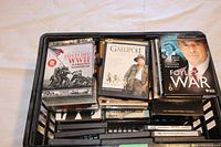 Photo of basket containing assorted DVDs showing some DVDs on top such as Our World History WWII 5-disc set, Gallipoli, and Foyles War Season 6.