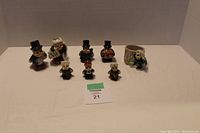 Full set of 8 ceramic bug figurines arranged on a flat surface, showing scale and grouping.