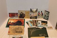 Wide view showing vintage books arranged with postcards and bird cards on display, featuring 'Treasures of British Columbia', 'Vancouver' book, and others along with postcards and card sets.