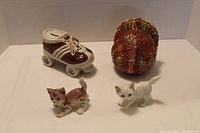 Ceramic roller skate bank, turkey dish, and two ceramic cats displayed together