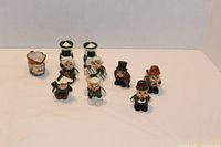 Overview of the lot with 9 small vintage ceramic items including salt and pepper shakers and figurines on a plain white background.