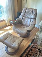 Armchair and ottoman with attached tray seen from front left angle