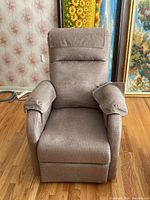 Front view of beige fabric power lift recliner chair with cushioned armrests and padded backrest.