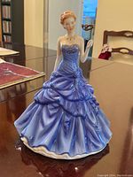 Front view of figurine showing gown and mask