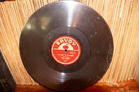 Close-up photo of a single 78 RPM vinyl jazz record by Frank DeLorio titled 'It's Easy to Remember' on the Savoy label, showing black vinyl and red label.