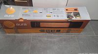 Box packaging for Aura CF 3000 electric patio heater showing brand and product image.