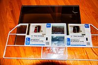 Two new 12 inch white metal tray dividers still in their retail packaging, brand Mainstays, designed for cabinet space organization.