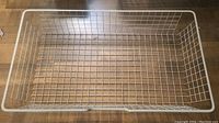 White wire storage basket viewed from top showing grid pattern and rectangular shape.