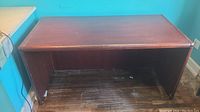 Photo of solid wood desk front view showing overall condition and scratches