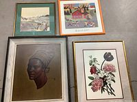 Overview of all four framed artworks laid on floor showing various sizes and frame styles