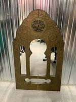 Front view of vintage Moroccan style mirror showing decorative embossed patterns and mirror panels