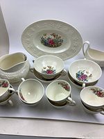 Wide photo showing all pieces including the platter, cups, creamers, and sugar bowl arranged on white surface
