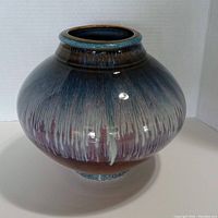 Front view of the rounded art pottery vase showing the glazed effect and shape.