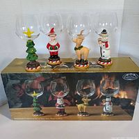 Photo showing front view of all four Christmas character goblets on box - tree, Santa, reindeer, snowman