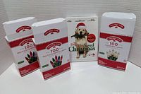 Three boxed sets of Holiday Times LED Christmas Lights and a sealed holiday-themed DVD arranged for display.