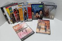 DVD cases fanned out showing front artwork including Wakefield, Real Bites, Napolean Dynamite and others.