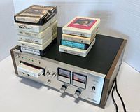 Front and side view of Pioneer Centrex RH-60 eight track player with multiple 8-track tapes stacked on top of the unit.