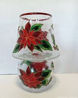 Front view of the poinsettia crackle glass candle lamp showing painted floral details on lampshade and holder.