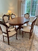 Overview of dining table and six chairs in room