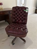 Front view showing tufted seat and back, nailhead trim
