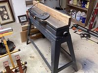 Front left angle view of jointer/planer on stand with wooden fence attachment