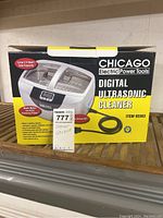 Photo of the Chicago Electric Power Tools Digital Ultrasonic Cleaner original box showing a picture of the ultrasonic cleaner and its features.