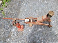 Photo showing three jacks: hydraulic floor jack, hydraulic bottle jack, and screw jack on gravel surface