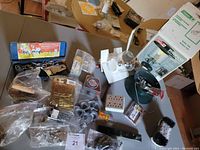Wide view of all items including lantern box, hardware, label tapes, tape measure on table