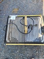 Top-down photo of the Workforce tile saw showing the metal cutting surface and power cord wrapped and attached.