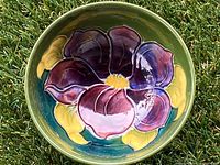 Top view showing Moorcroft floral design in purple, yellow, and green colors with a glossy finish.