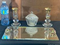 Full set on black surface with water bottle for scale, showing tray, two candle holders, and sugar bowl