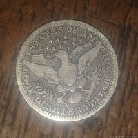 Reverse side of the 1909 US Barber Quarter Dollar coin showing the heraldic eagle with shield, stars, and inscriptions.