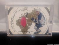 Photo of the card with the red jersey patch and player image in a holder.