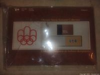 Front view of sealed Canadian Olympic Stamp Souvenir Collection in original plastic wrapper, showing the Olympic rings and title.