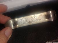 Close-up image of vintage Eko Canada metal can piercing tool, showing brand markings and size.