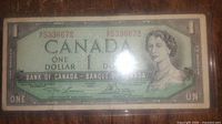 Front side of the 1954 Canadian one dollar banknote featuring Queen Elizabeth II and serial number 5336672.