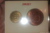 Front view of the sealed coin set showing the 3 pence and 1 penny coins with Jersey coat of arms