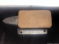 Top view showing flat anvil surface with horn extending to the left. Two holes for mounting are visible on the base.