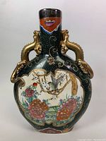 Front view showing floral and bird hand-painted scene with gold dragon handles on side