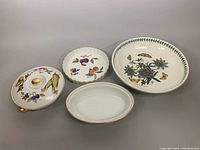Four dishes: three Royal Worcester Evesham dishes and one large Portmeirion floral bowl