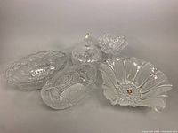 Full set of five clear cut glass bowls and dishes, including floral Waltherglass bowl, lidded dish with chips, and other bowls with decorative patterns