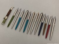 Top down view of all pens and letter opener showing variety in colors and finishes