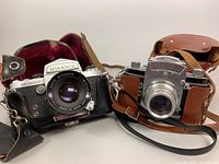 Miranda Sensomat and Jhagee Dresden Exa cameras side by side with original leather cases.