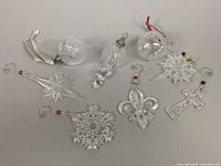 Overview of all eight crystal ornaments laid out on flat surface