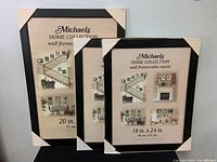 Three new Michael's Home Collection photo frames with black finish and protective corner covers, showing paper inserts demonstrating wall frame usage.