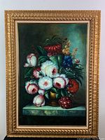 Full view of framed oil painting showing floral bouquet in ornate gold frame.