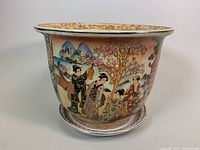 Front view showing geisha figures and cherry blossom tree scene on planter pot with matching under-plate.