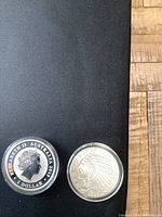 Obverse side of both coins showing Queen Elizabeth II on Australian Kookaburra and Native American Indian head on 1929 coin